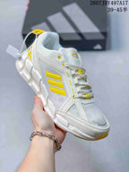White Adidas Climacool Ventage sneaker with bright yellow side stripes, eyelets, and outsole accents.