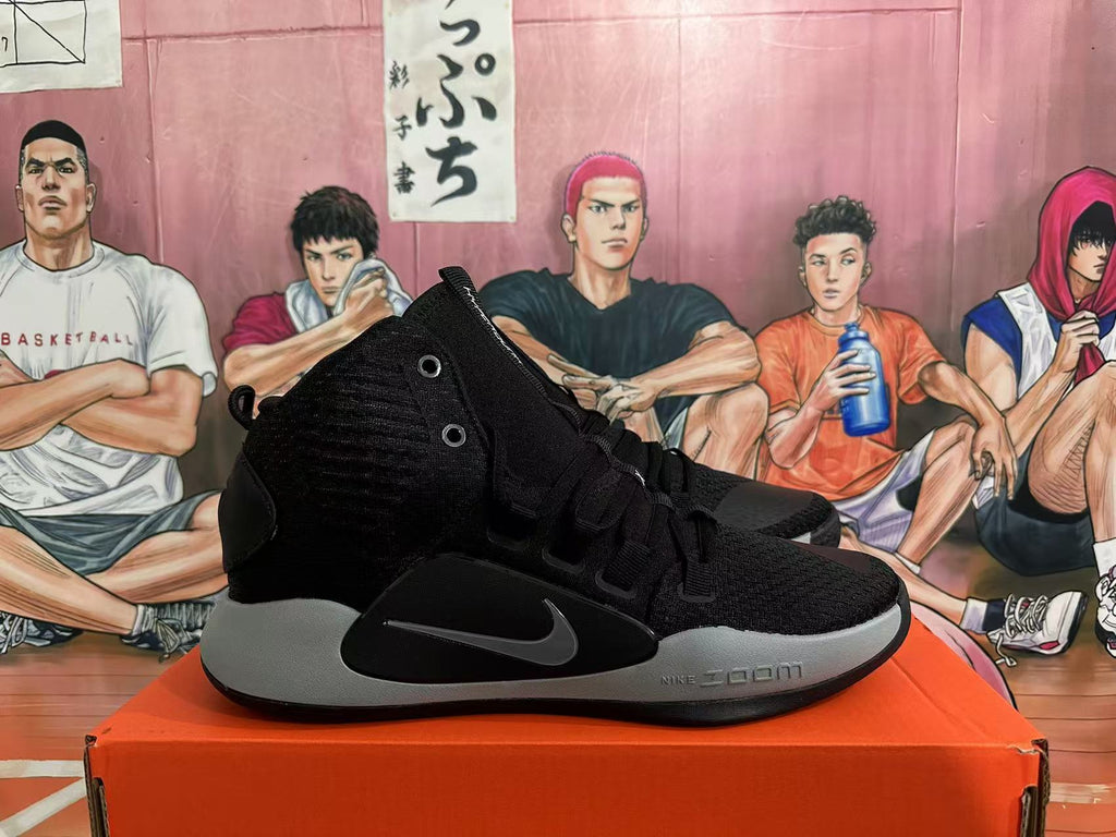 Side view of a black Nike Hyperdunk basketball shoe with grey midsole and Swoosh