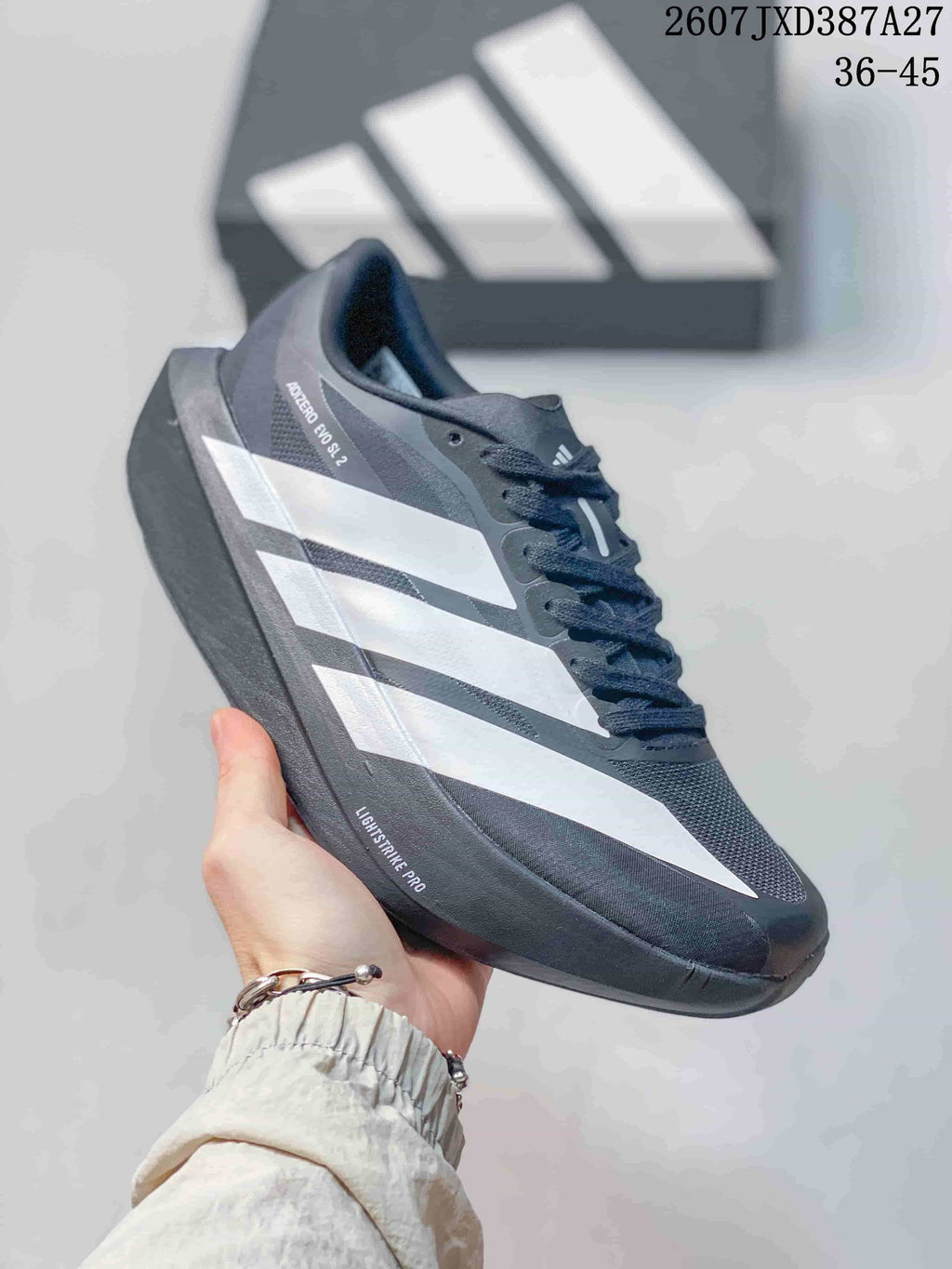 Side view of the adidas sneaker showing the Adizero Evo SL marking, white stripes and Lightstrike Pro text on the midsole area.