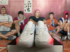 Front view of white Nike basketball shoes with pink accents