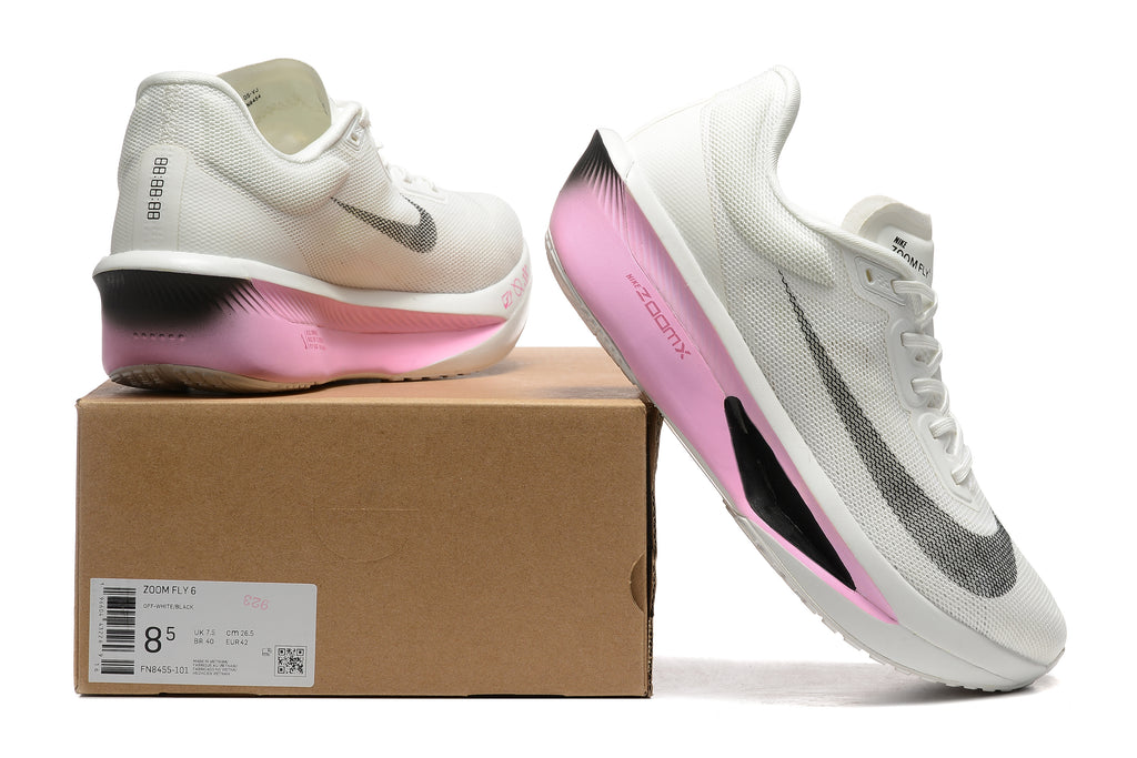 White Nike Zoom Fly 6 shoes with pale pink and black accents beside a box showing a sample size label