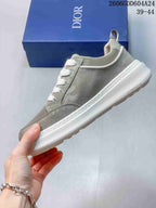 Side profile of a gray-green Dior sneaker with white laces and outsole
