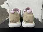 Rear view of white and grey Nike basketball shoes with pale pink collar lining and heel graphics.