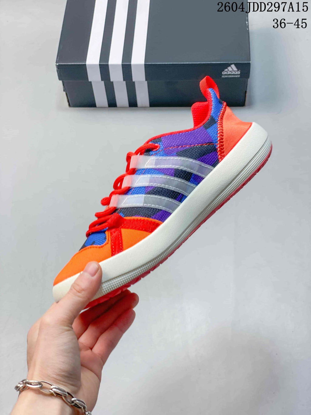 Side profile highlighting the colorful mesh-style upper, translucent overlays, white midsole and coral outsole.