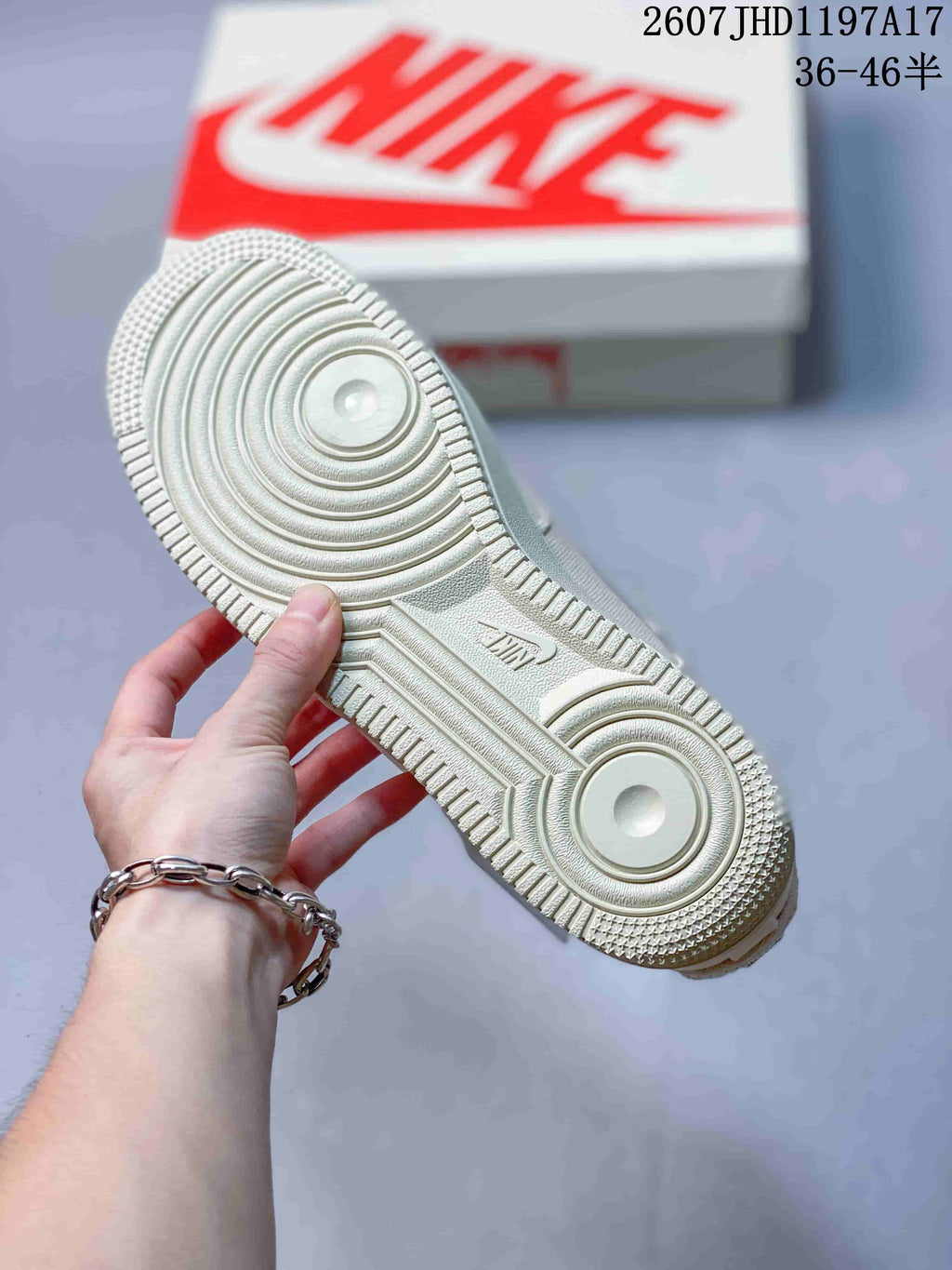 Cream sneaker outsole showing the concentric-circle tread pattern and Nike branding.