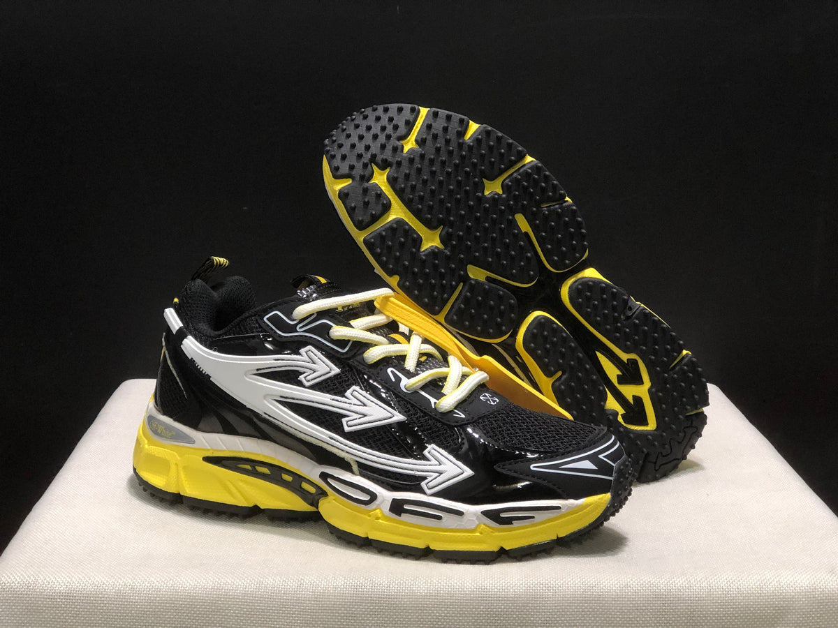 Sneakers shown from the side with one shoe lifted to display the black-and-yellow textured outsole.