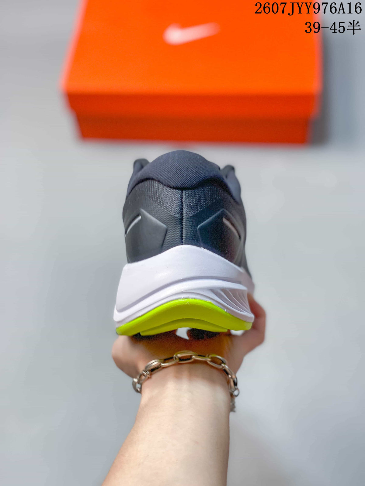 Rear view of the gray sneaker showing the padded collar, white midsole, and neon green outsole edge.