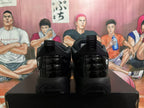 Rear view of a pair of black Jordan sneakers showing glossy heel panels, pull tabs, and Jumpman logos.