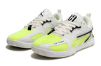 Pair of white and fluorescent lime Jordan Heir shoes, viewed from the front