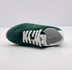 Top view of a green Alo sneaker showing the white laces, tongue branding, and padded collar.
