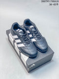 Pair of navy adidas Adipista sneakers with white stripes displayed on a shoebox.