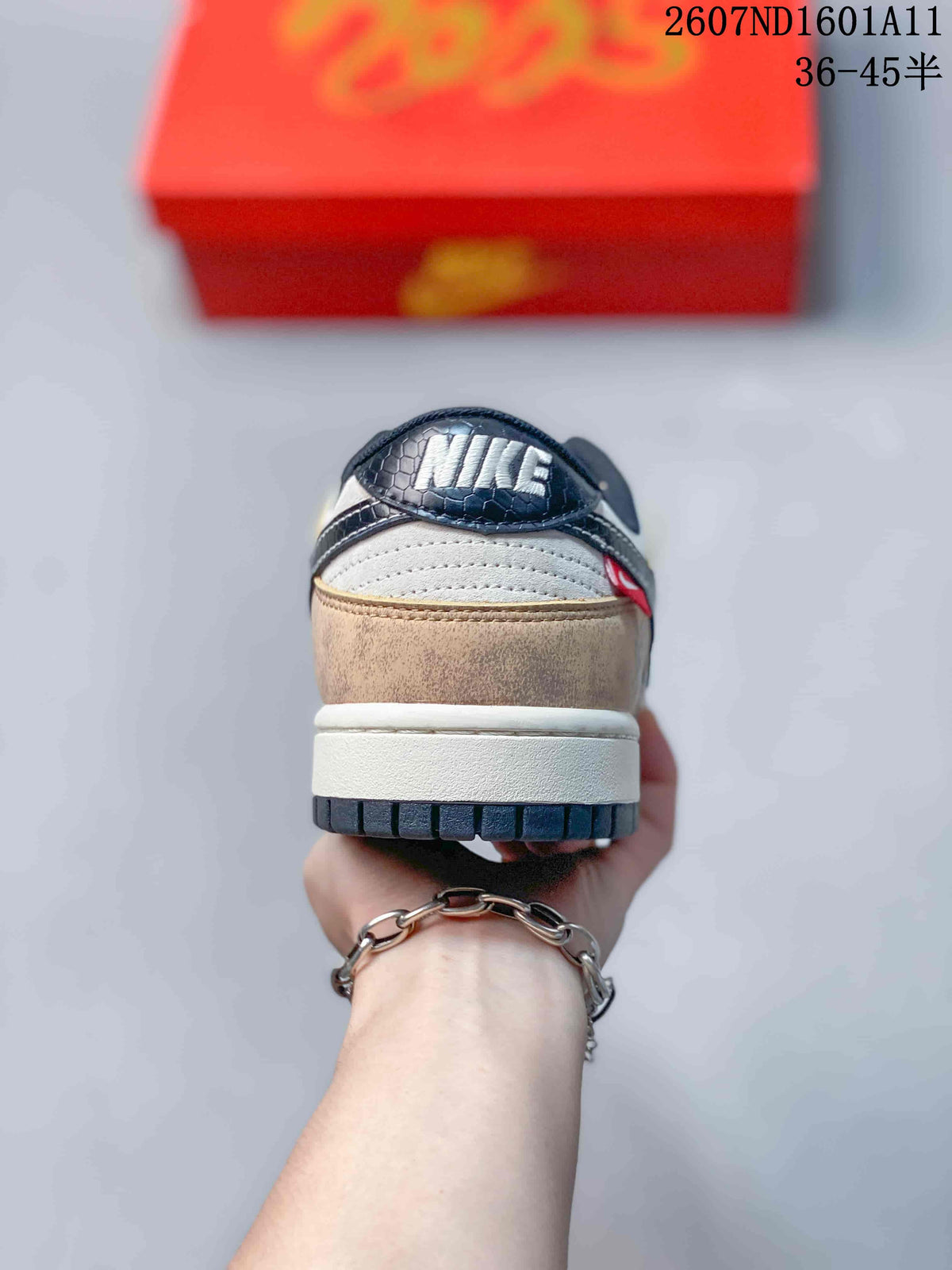 Rear view showing the tan heel panel, white midsole, navy outsole edge, and branded heel detail.