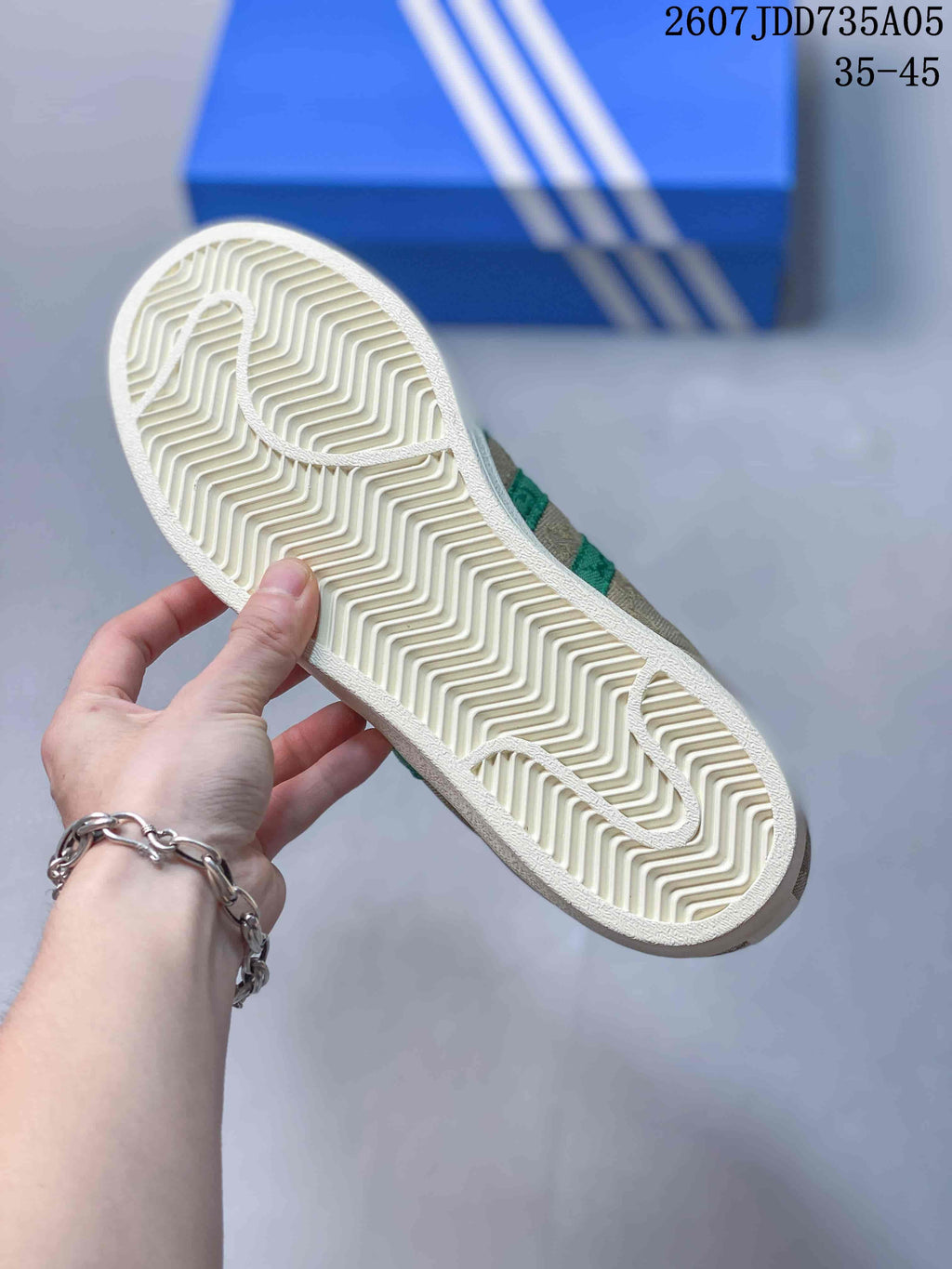 Close-up of the cream outsole showing its repeating herringbone tread pattern.