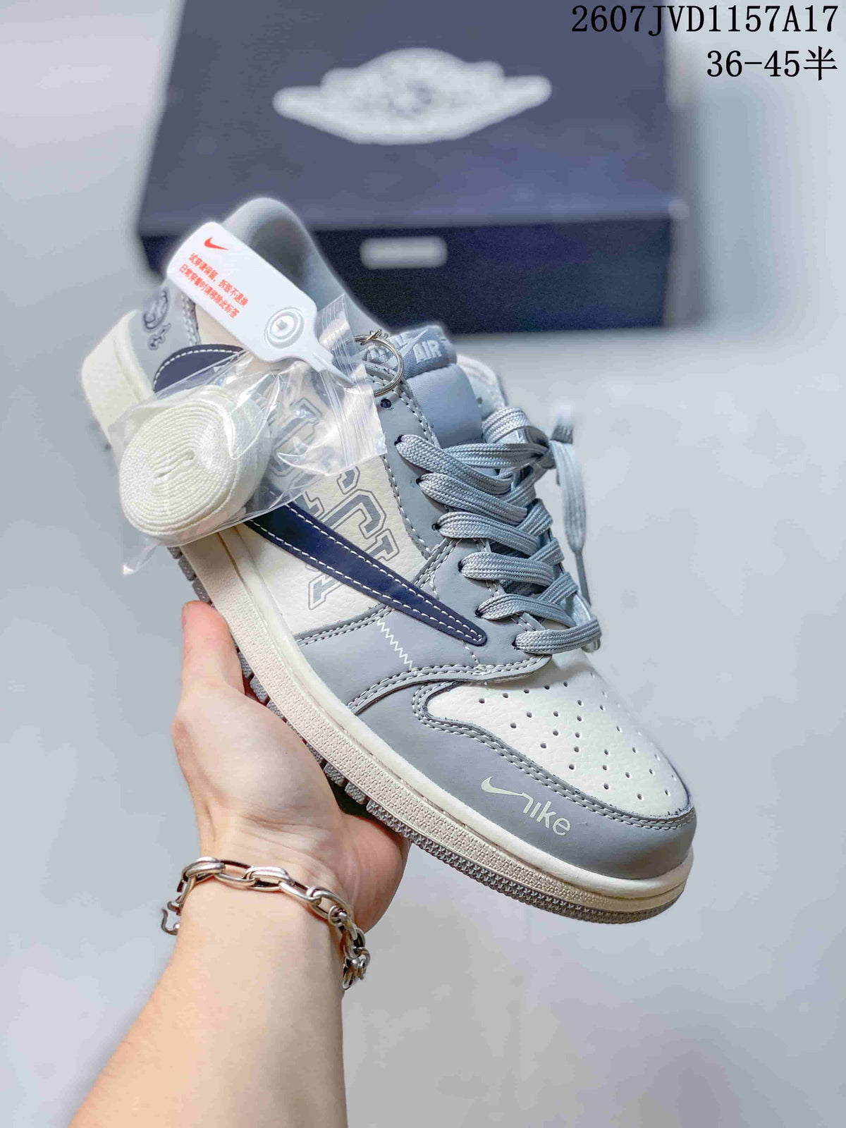 Gray and white low-top sneaker with layered panels, gray laces, and contrasting swoosh-style details.