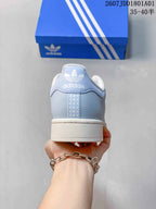 Rear view of the light blue Adidas Superstar sneaker with white heel logo