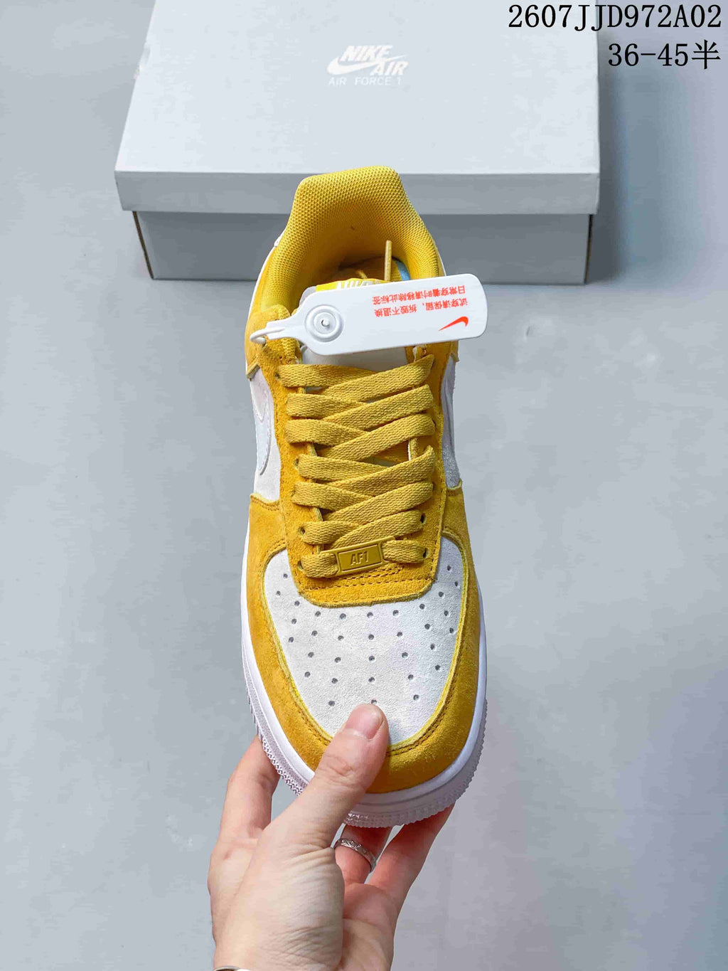 Top view of the yellow and white Nike Air Force 1 sneaker, showing its perforated toe panel and yellow laces.