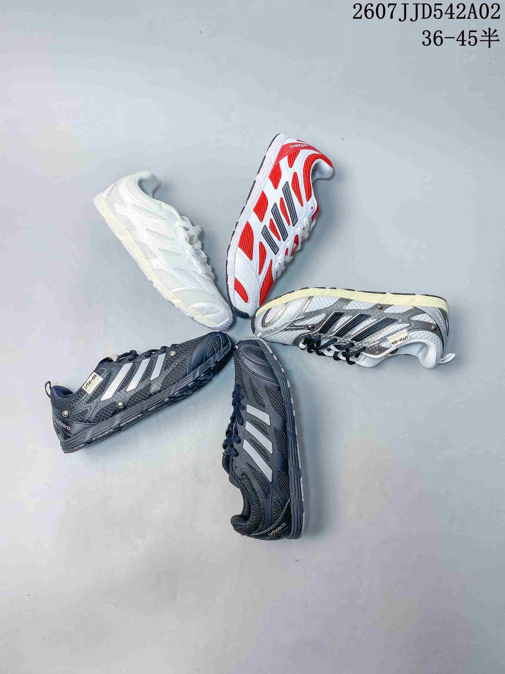 Several sneaker colorways arranged together, including white, red, silver-toned and charcoal