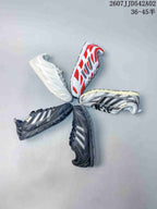 Several sneaker colorways arranged together, including white, red, silver-toned and charcoal