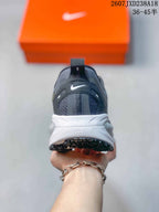 Rear view of the dark gray running shoe showing the heel pull tab, Nike branding, white midsole, and black outsole.
