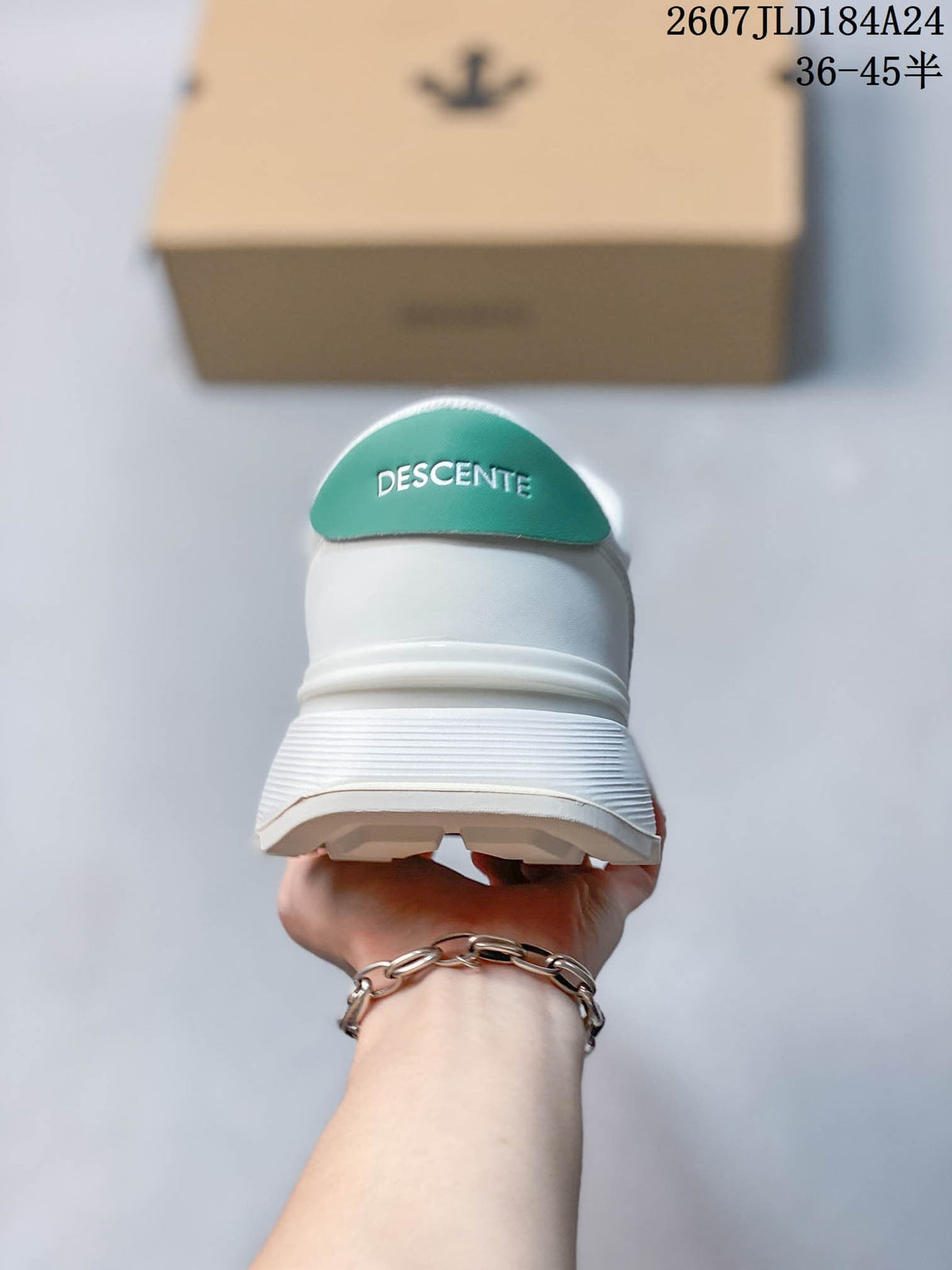 Rear view of the white sneaker showing the green DESCENTE heel tab and textured heel section.