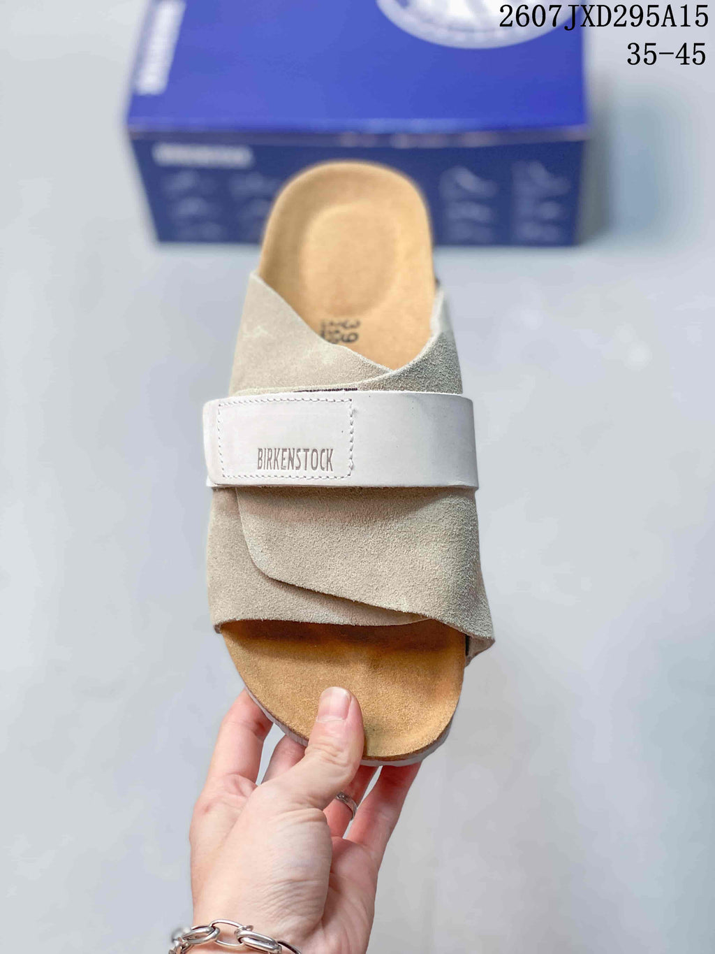 Top view of the sandal showing the open toe, overlapping upper straps, adjustable branded strap, and contoured footbed.