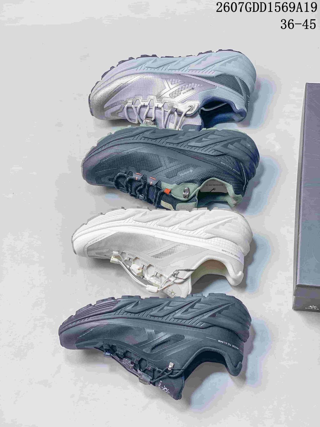 Four KAILAS trail shoes shown from the outsole and side, displaying white, gray, lavender and dark colorways.