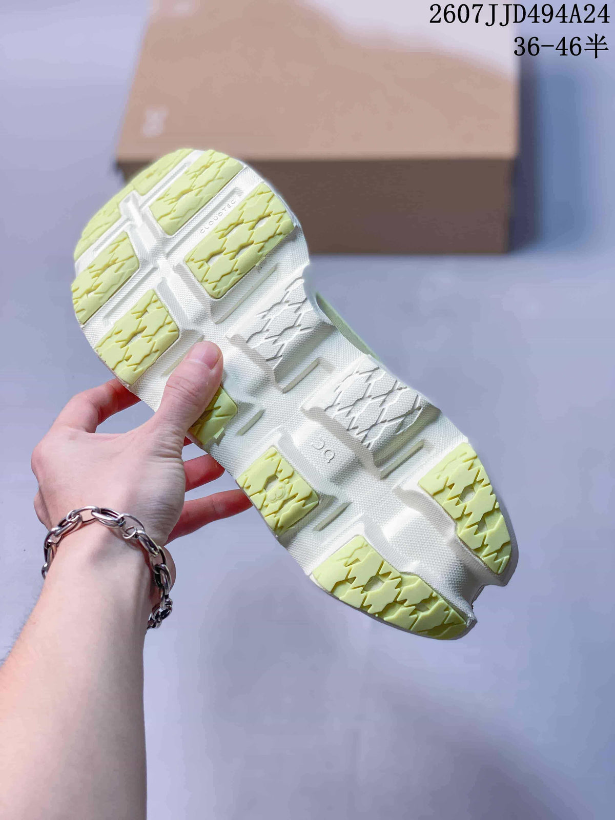 Close view of the sneaker outsole showing lime green and white tread sections with an open-section construction.