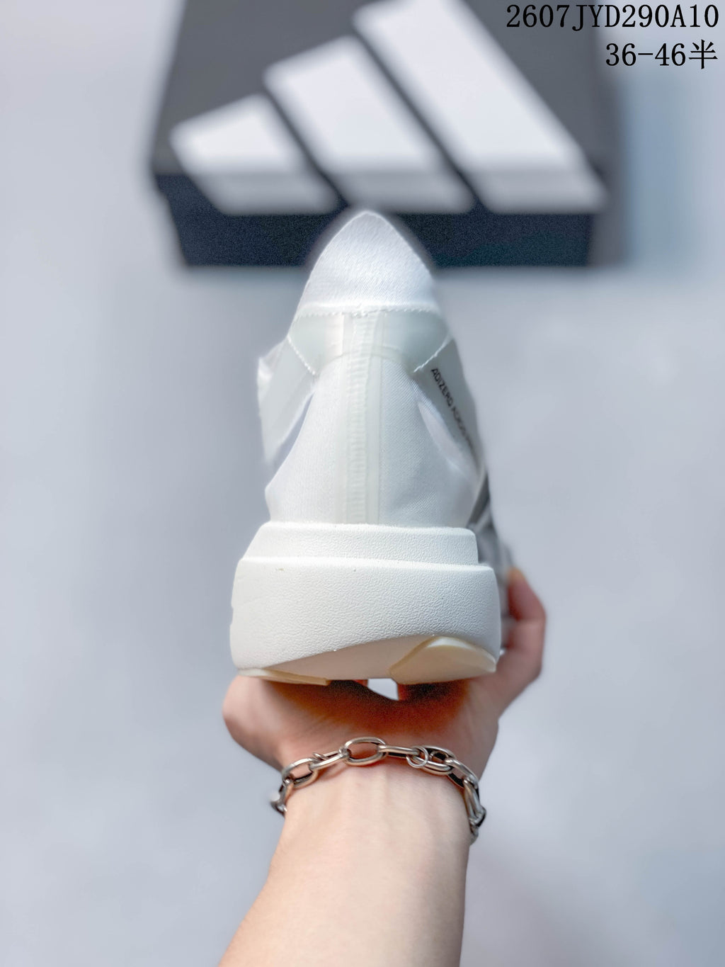 Rear view of the white running shoe showing the heel structure and outsole edge.