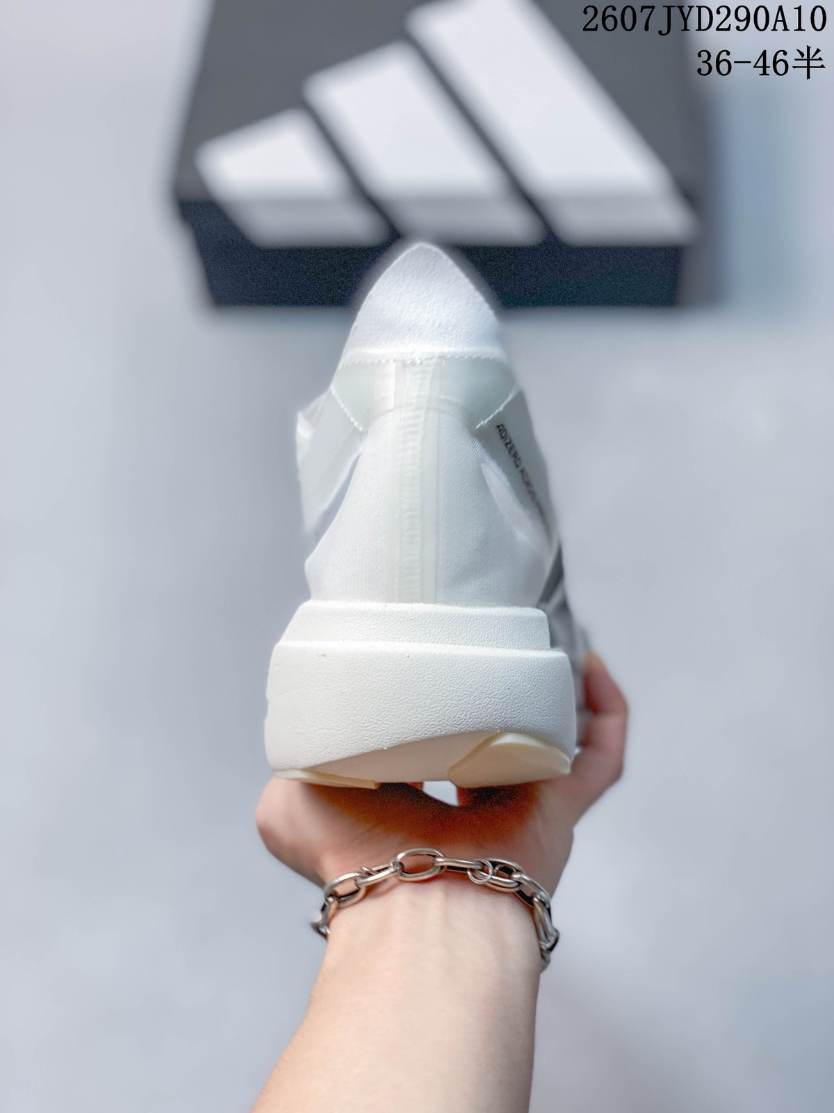 Rear view of the white running shoe showing the heel structure and outsole edge.