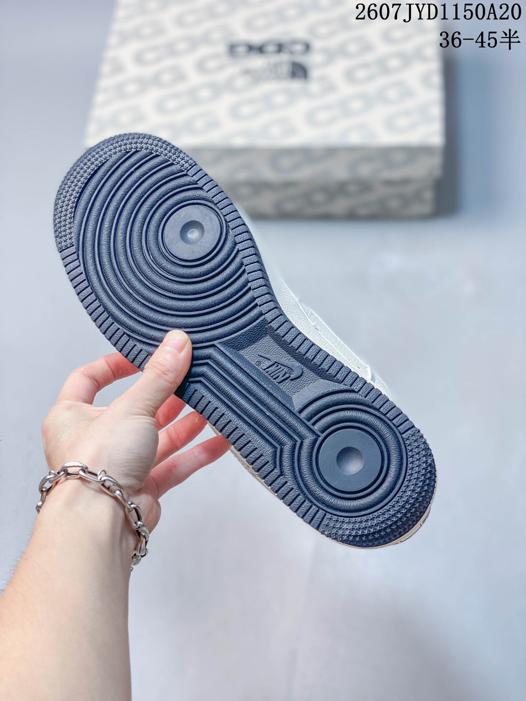 Close-up of the sneaker outsole showing a dark navy circular traction pattern.