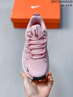 Top view of the pink training shoe showing the mesh-like toe area, layered laces, padded tongue, and dark toe detail.