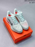 Pair of pale mint and white Nike sneakers with red cushioning details, displayed on an orange shoebox.