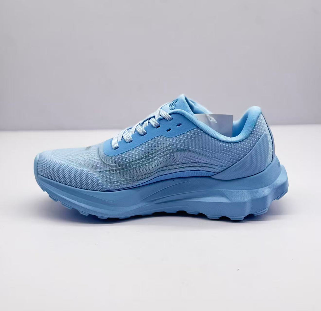 Opposite side view of the light blue Alo sneaker with a padded collar and lace-up design.