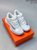 Pair of predominantly white Nike tennis shoes displayed on an orange shoebox.