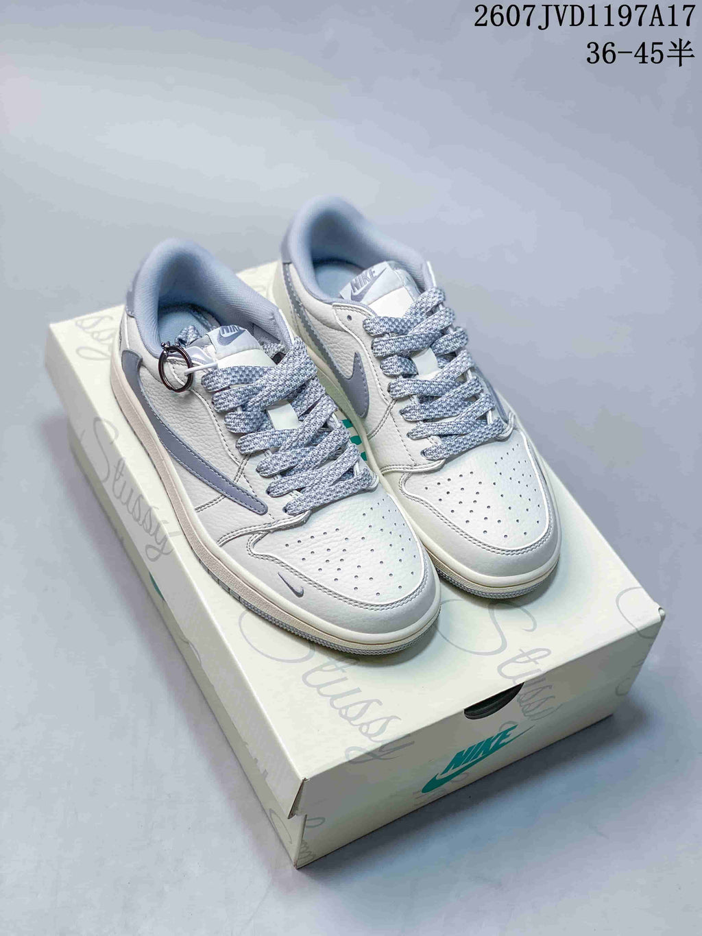 Pair of white and grey low-top Jordan sneakers displayed on a branded shoe box.