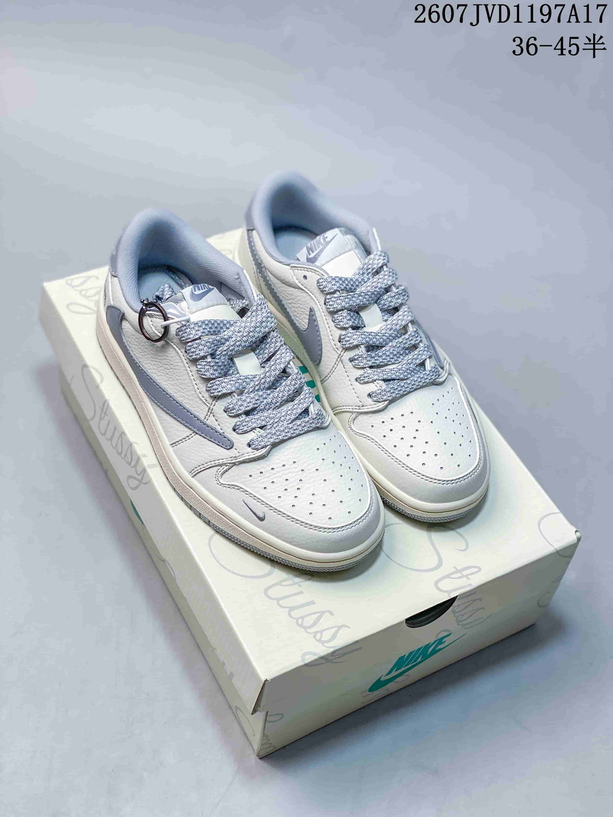 Pair of white and grey low-top Jordan sneakers displayed on a branded shoe box.