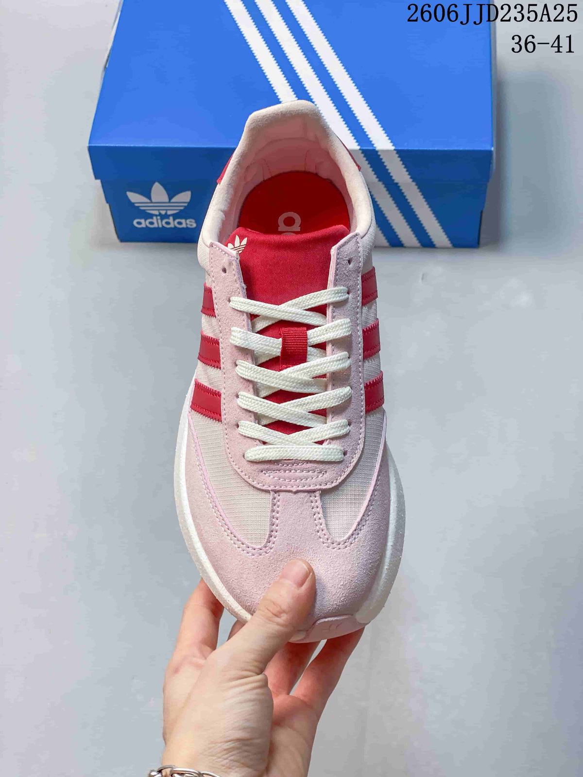 Top view of the pink sneaker showing white laces, red tongue and layered toe detailing.