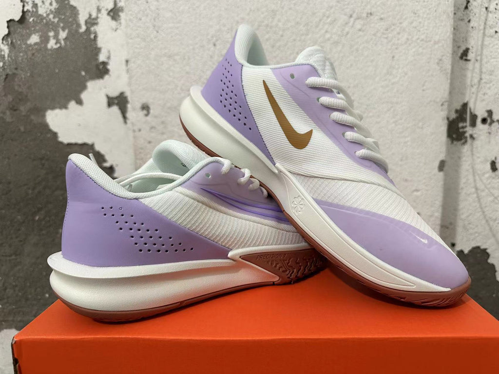 Pair of white and light purple Nike basketball shoes displayed from the side