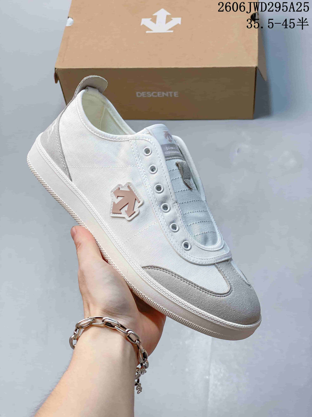 Side view of a white and gray DESCENTE sneaker with a side logo