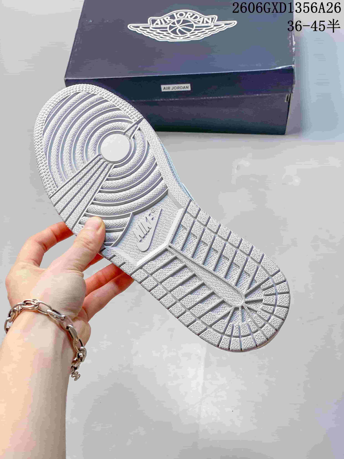 Close-up of the patterned outsole on a white and grey low-top sneaker