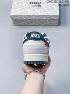 Rear view showing the navy heel tab, off-white panels, and red accent tab