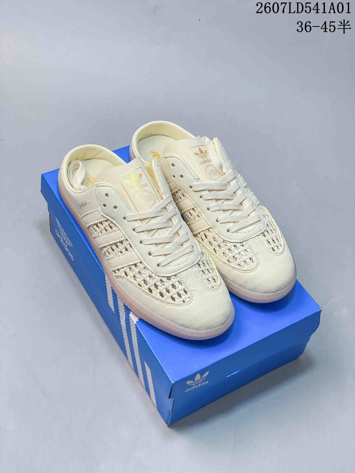 Pair of ivory-toned Adidas Samba OG Mule sneakers with woven-look panels and pale pink-looking soles, displayed on a blue box.