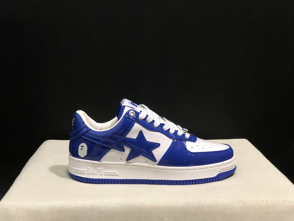 Close side profile showing the blue upper, white midsole, star-shaped side detail, and blue outsole.