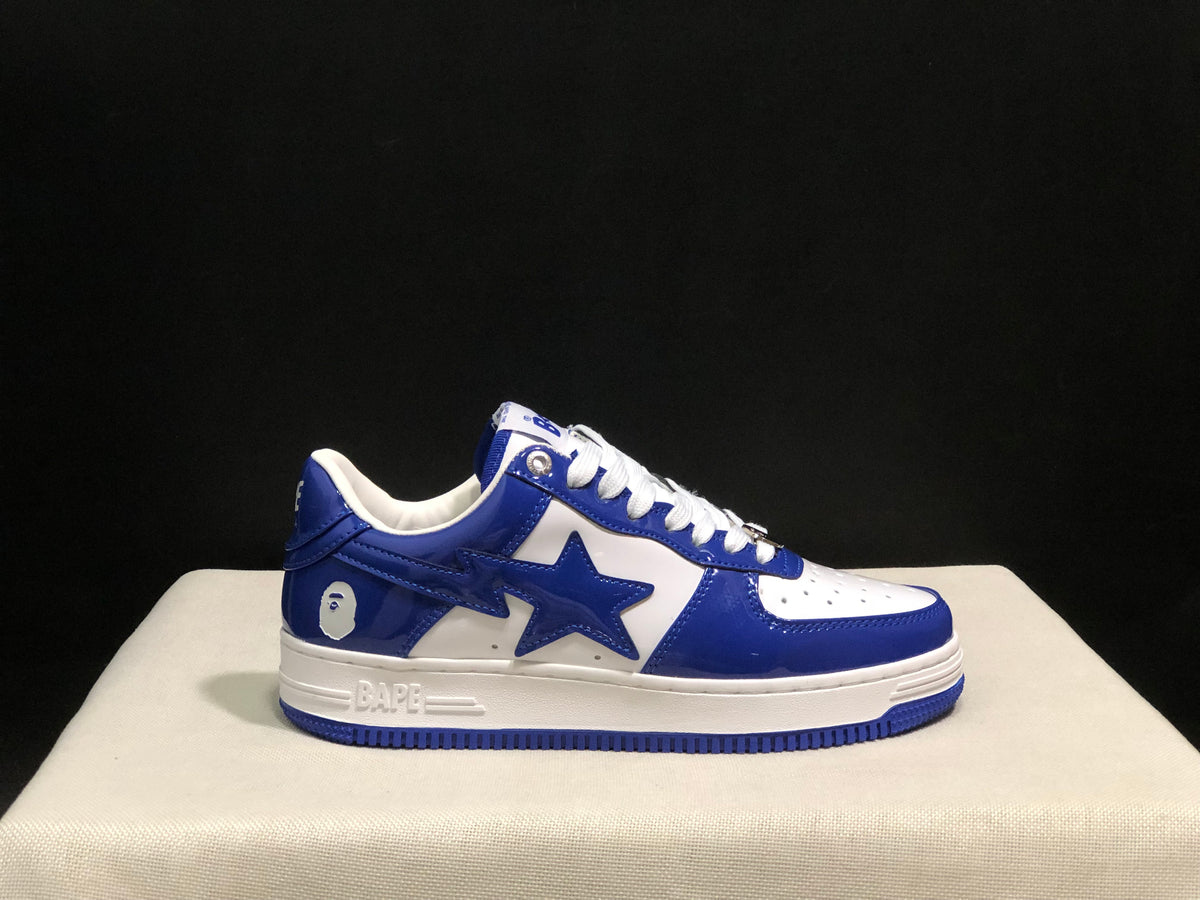 Close side profile showing the blue upper, white midsole, star-shaped side detail, and blue outsole.