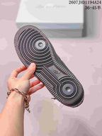 Close view of the black sneaker outsole showing concentric circular traction and a textured perimeter.