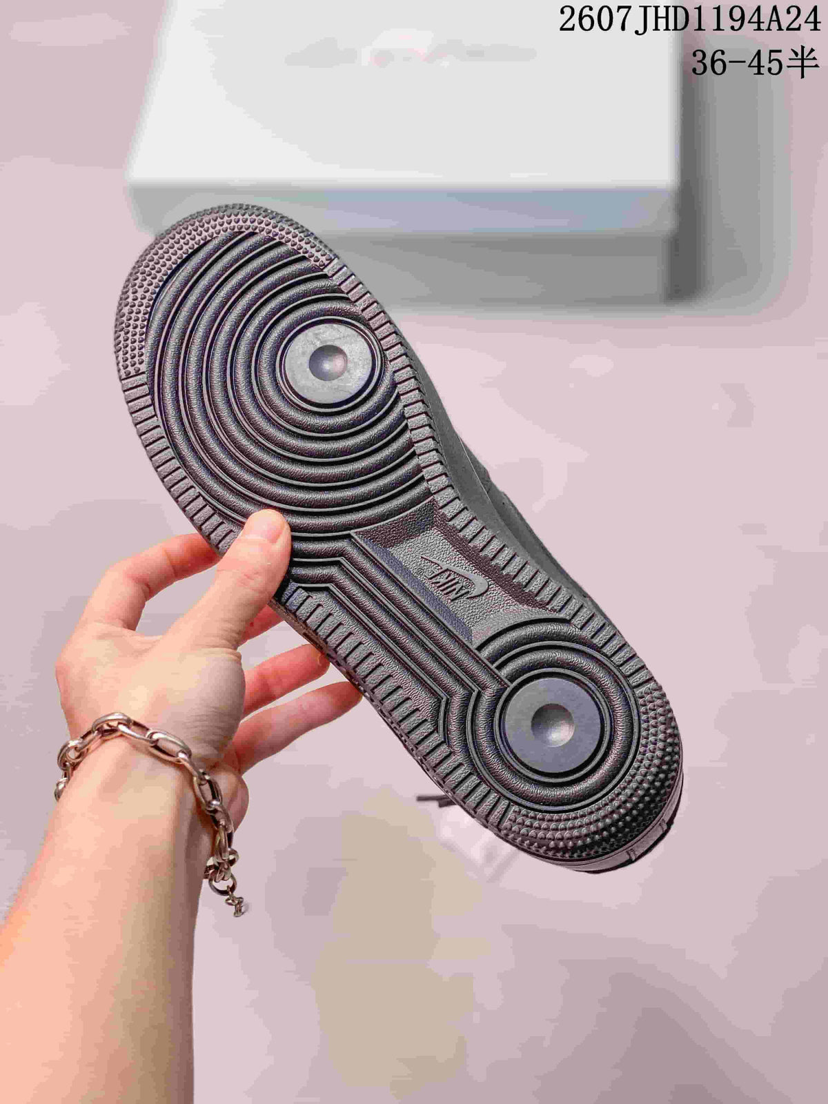 Close view of the black sneaker outsole showing concentric circular traction and a textured perimeter.