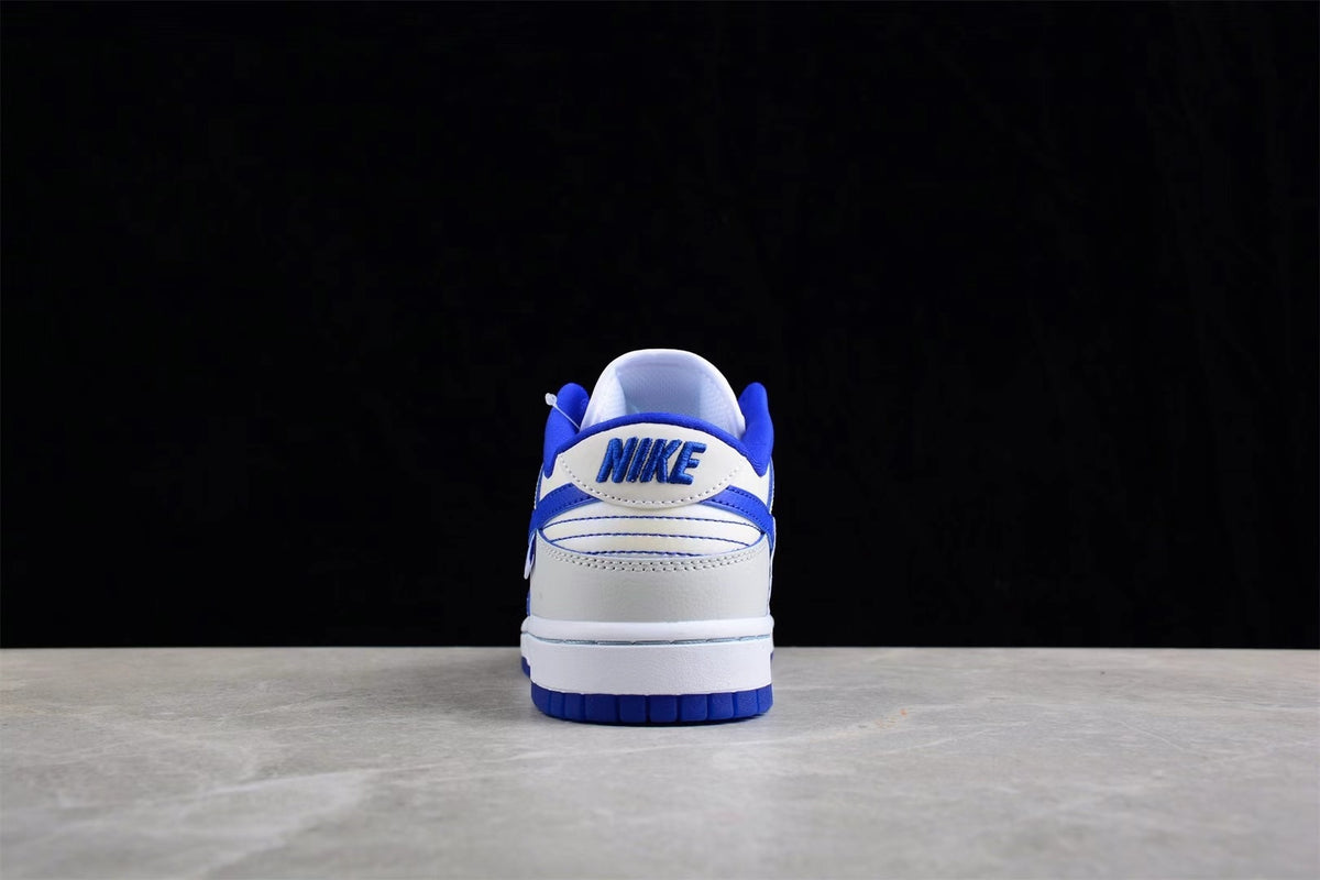 Rear view showing blue heel branding, white heel panels, and blue outsole sections.
