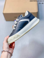 Side profile showing the navy upper, white side panel, contrast stitching, and thick off-white outsole.