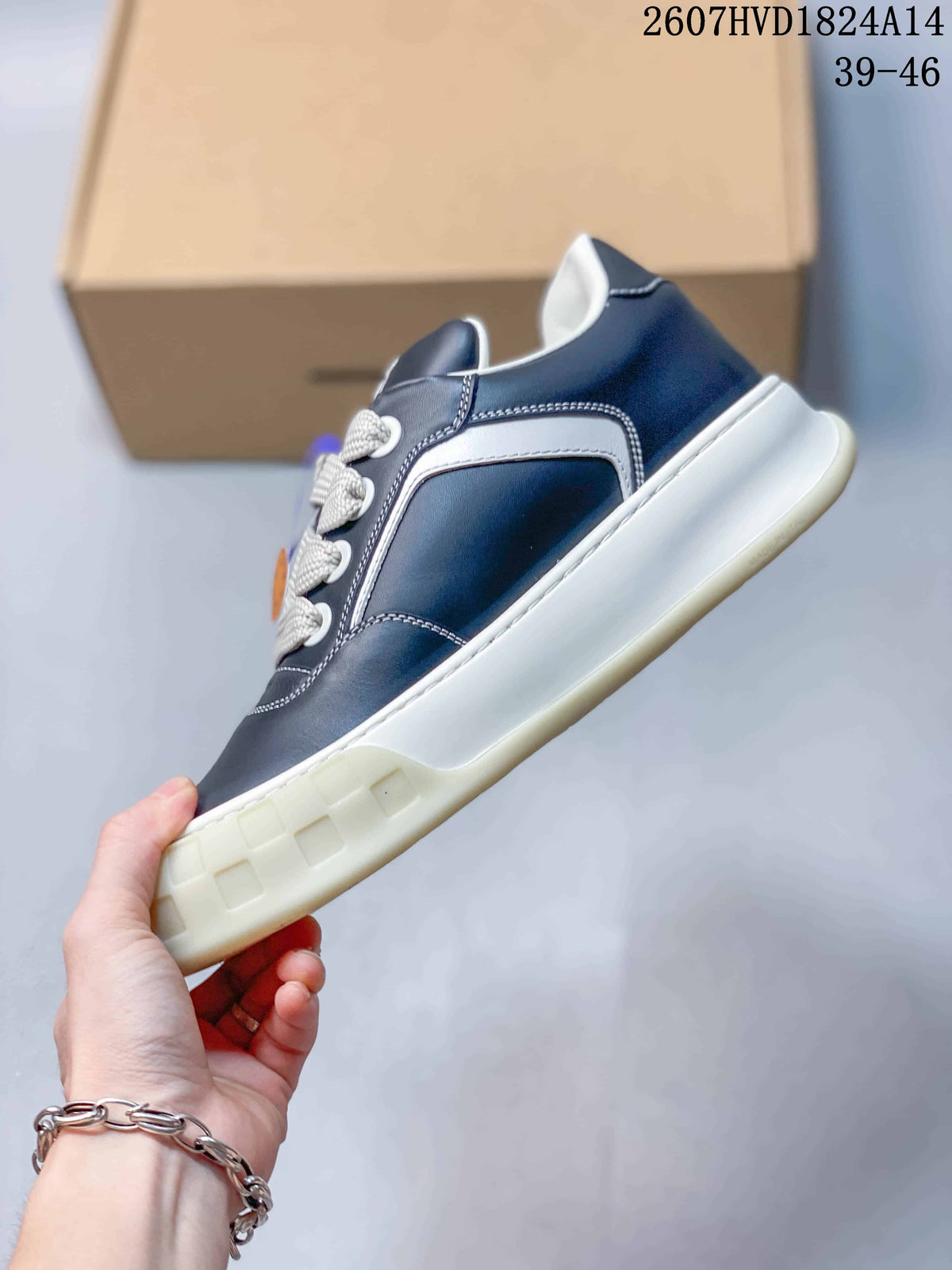 Side profile showing the navy upper, white side panel, contrast stitching, and thick off-white outsole.