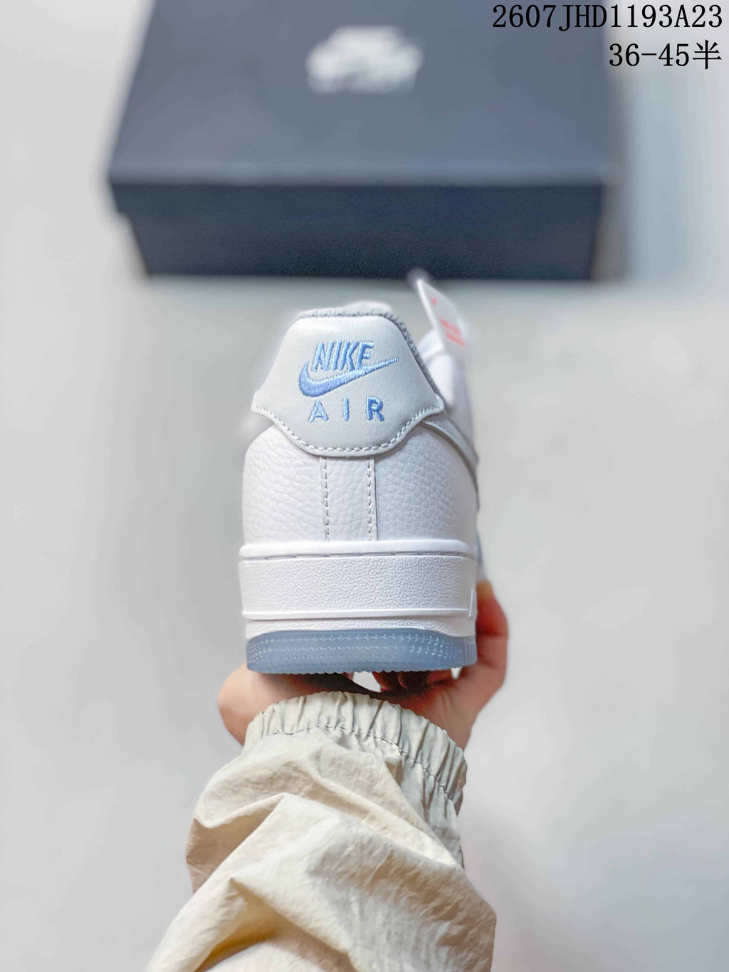 Rear view showing the white heel panel, Nike Air branding, and translucent blue outsole edge.